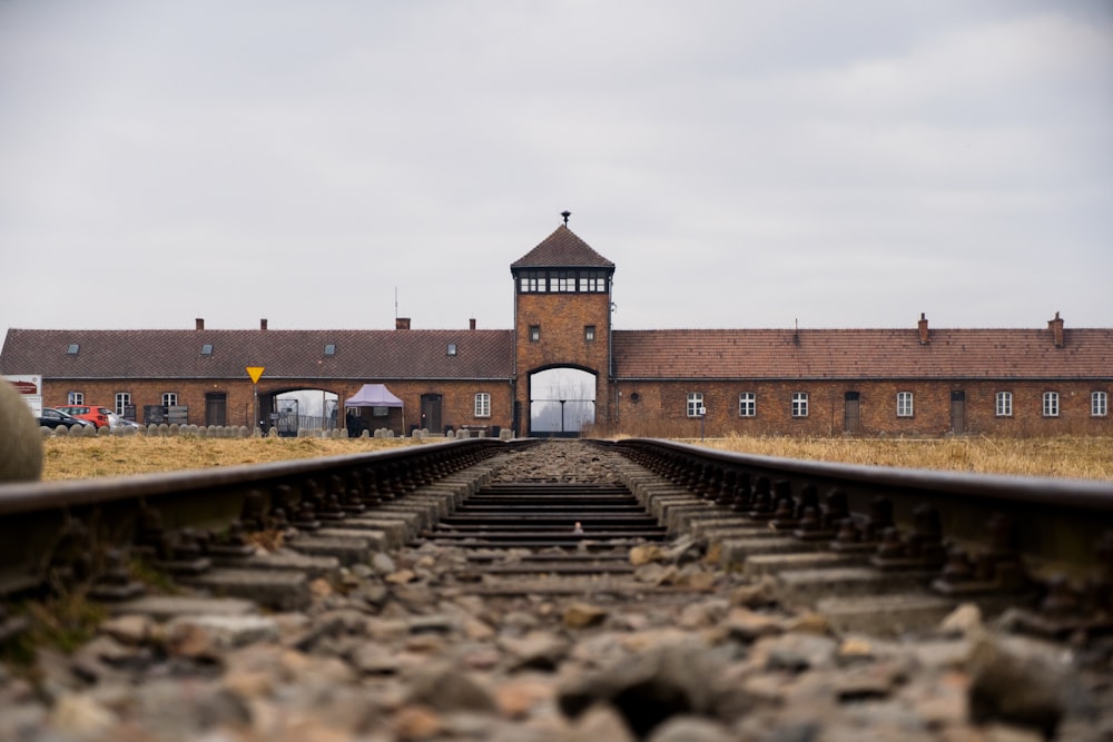 a train track with a building in the background