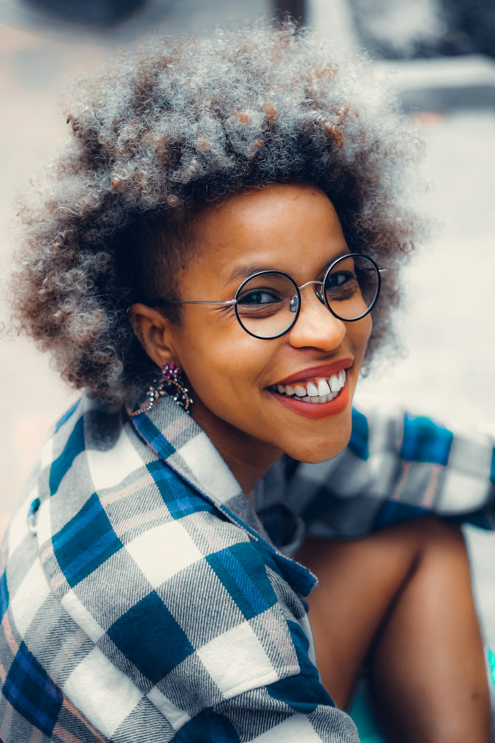 a woman wearing glasses and a plaid shirt
