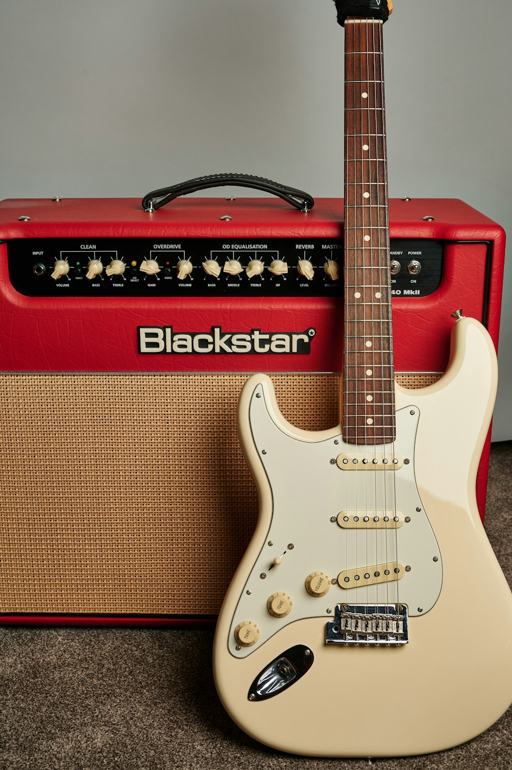 a guitar and amp sitting on a carpet