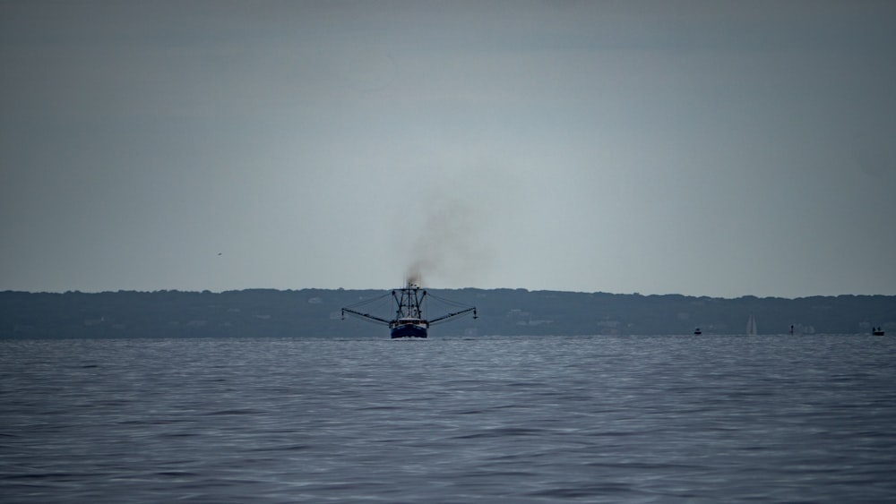 a boat floating on top of a large body of water