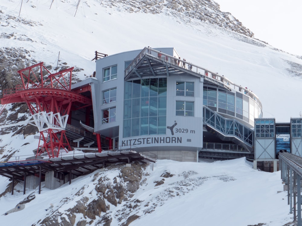 a snow covered mountain with a building on top of it