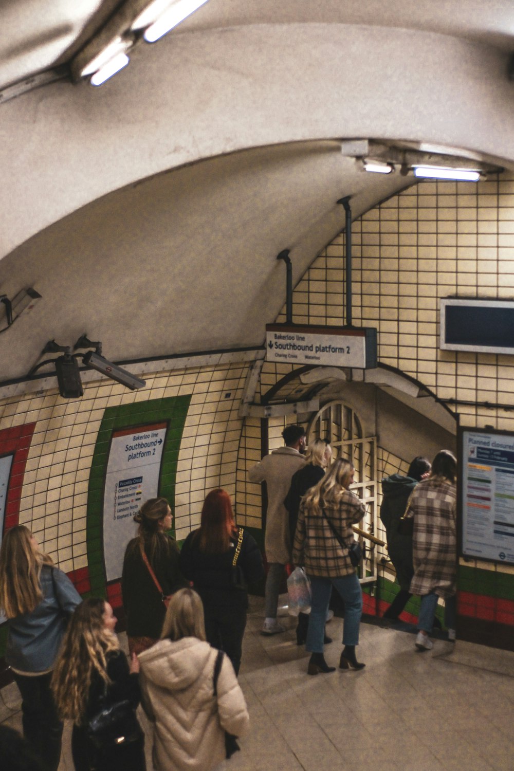 a group of people standing in a subway station