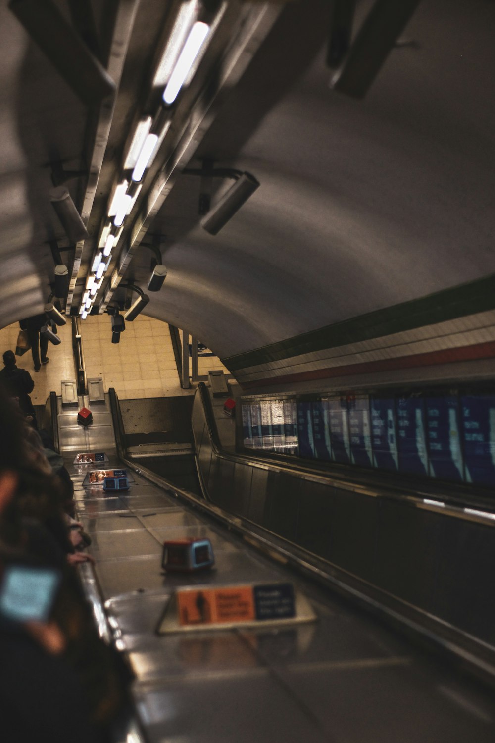 a subway station with people on the escalator