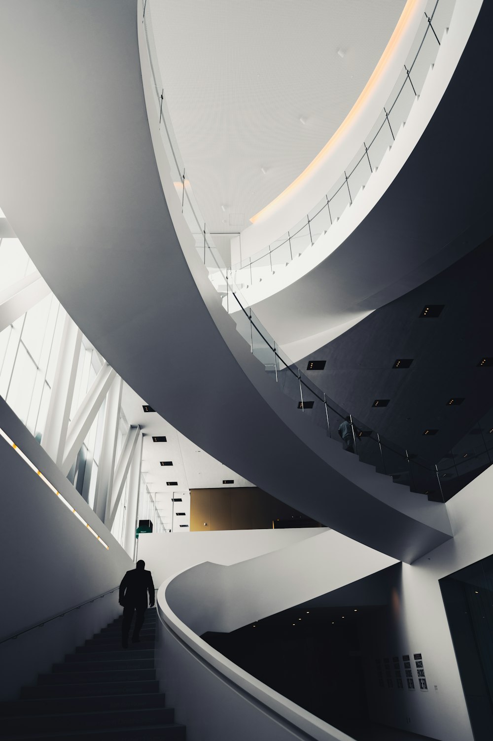 a man walking up a flight of stairs in a building
