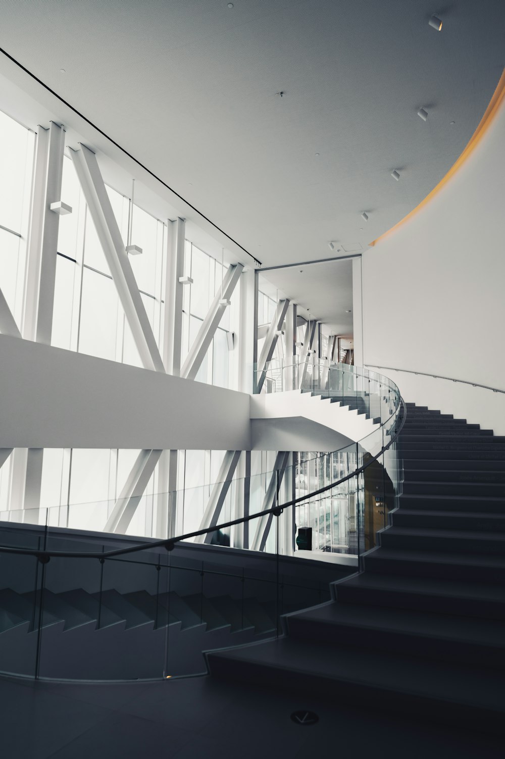 a staircase in a large building with glass walls