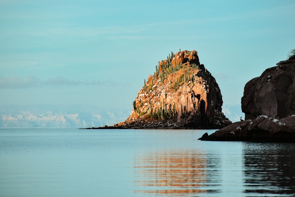 a rock outcropping in the middle of a body of water