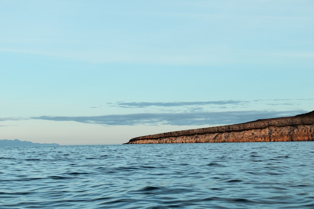 a large body of water with a small island in the distance