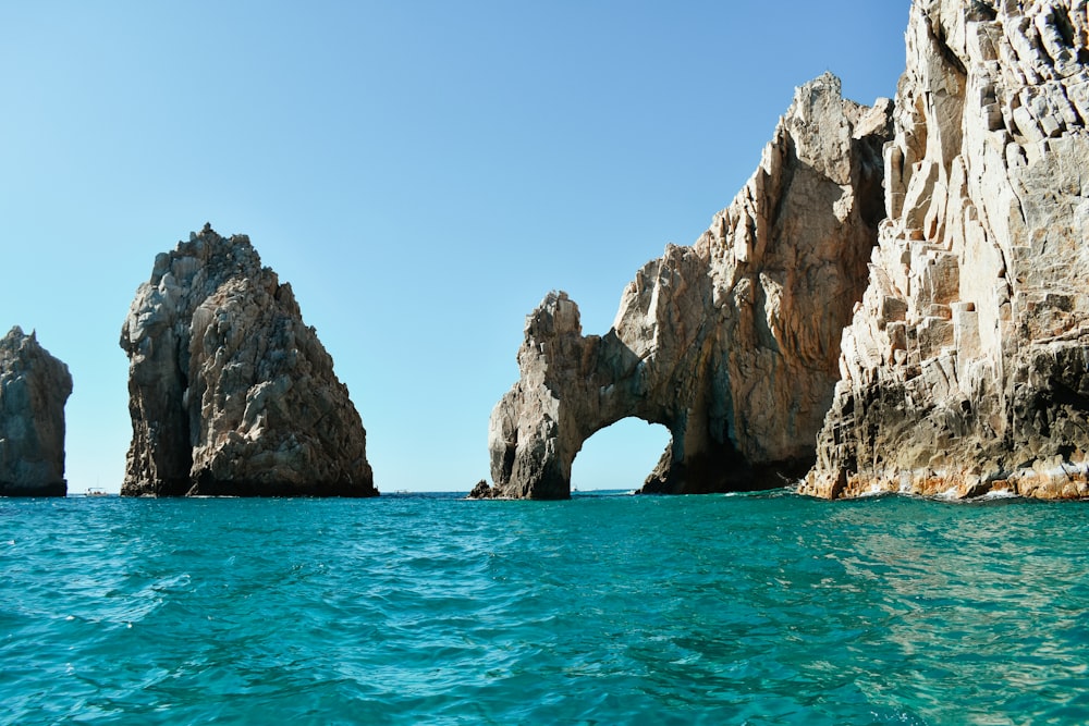 a rock formation in the middle of a body of water