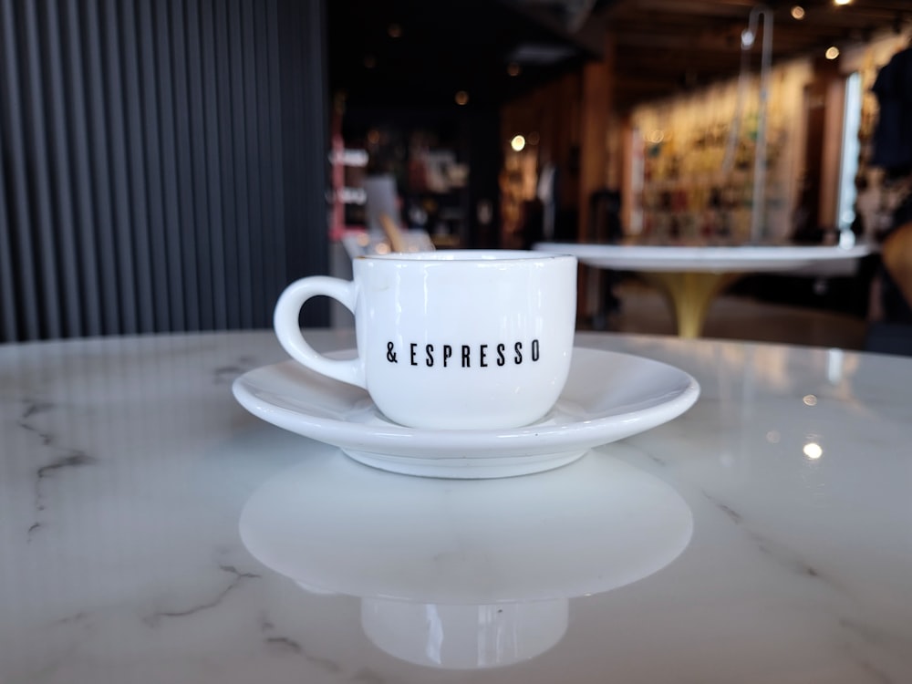 a white coffee cup sitting on top of a white saucer