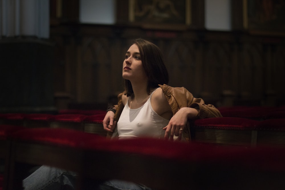 a woman sitting in a theater looking up