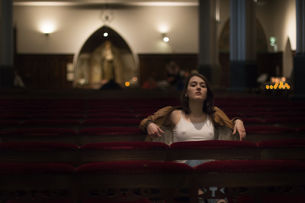 a woman sitting in a theater looking up