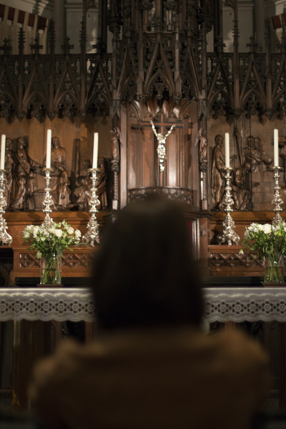 a person sitting in front of a church alter