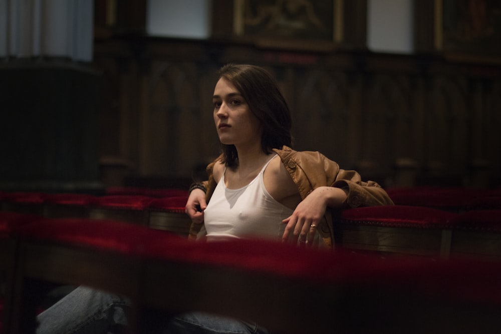 a woman sitting in a theater looking off into the distance