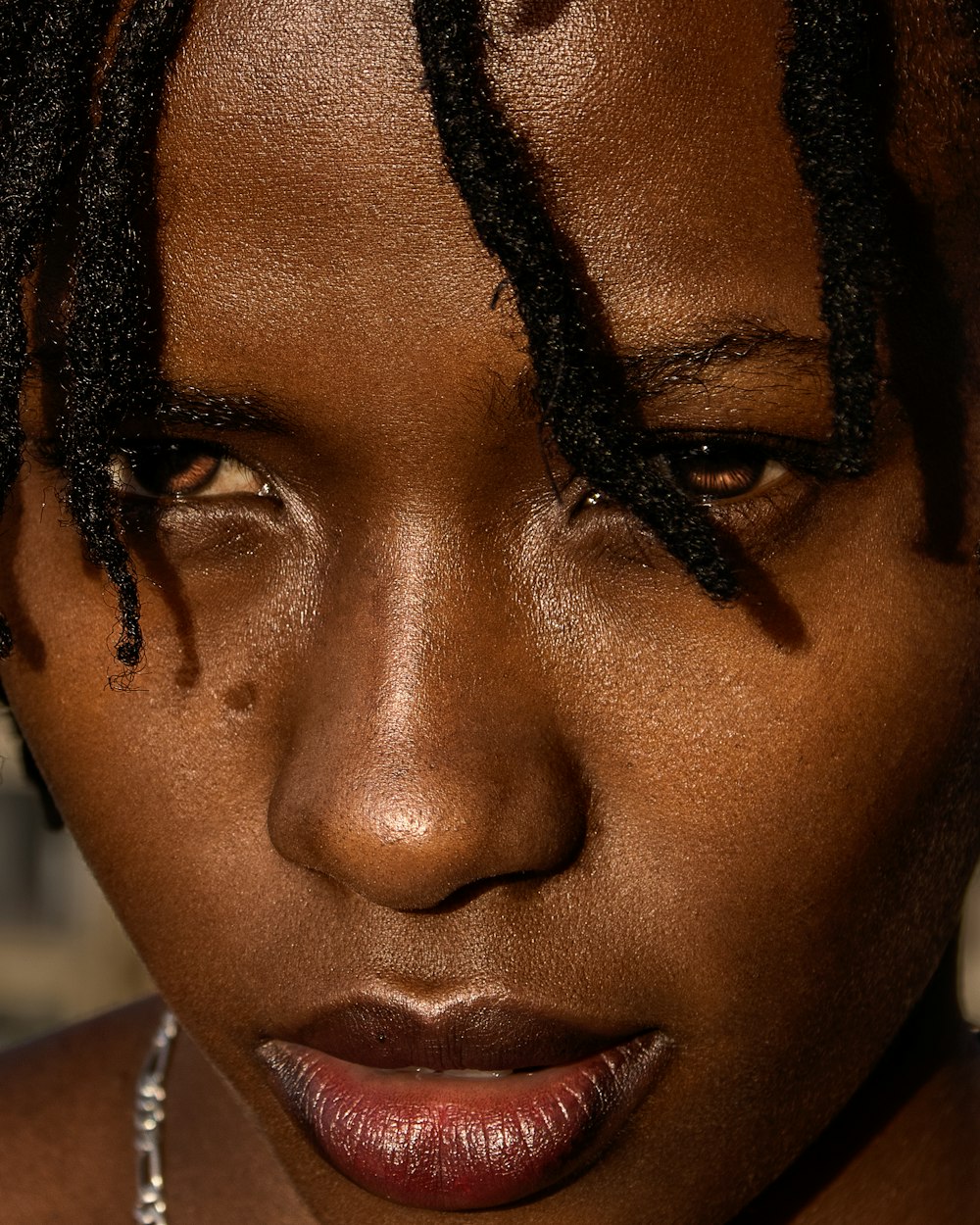 a close up of a woman with dreadlocks