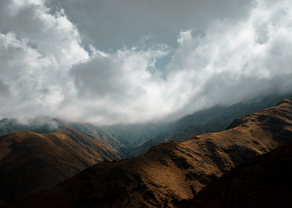 a view of a mountain range under a cloudy sky