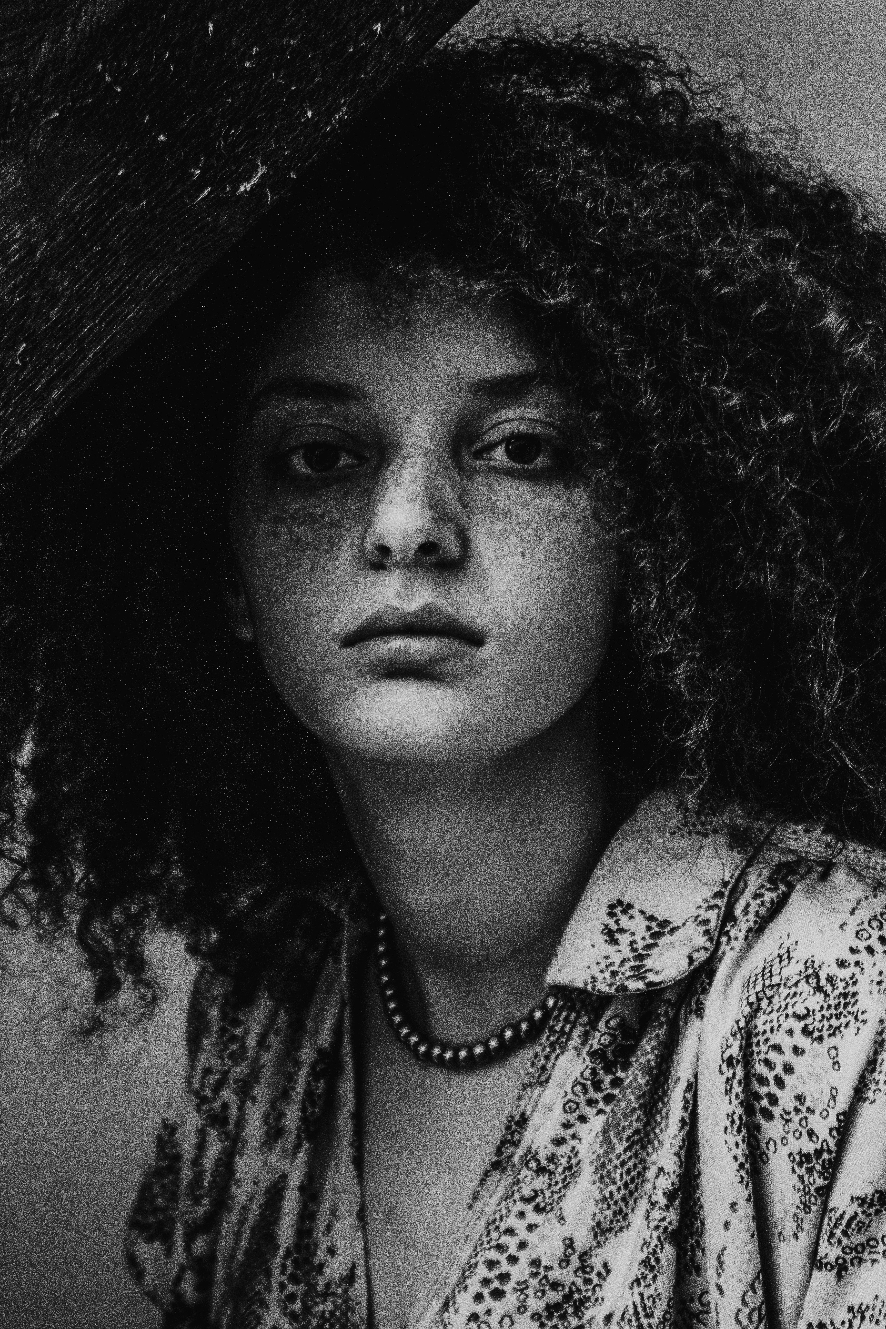 a black and white photo of a woman with curly hair