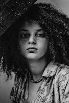 Muted color palette portrait, focusing on expression and storytelling through simple wardrobe and setting.