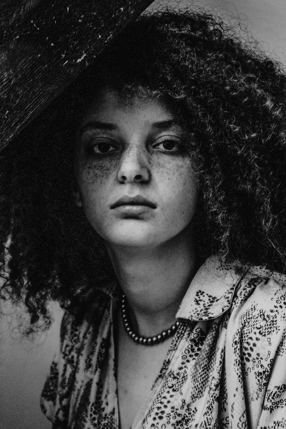 a black and white photo of a woman with curly hair