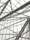 Complex geometric metal framework with intersecting beams visible through a transparent ceiling, likely part of an architectural structure.