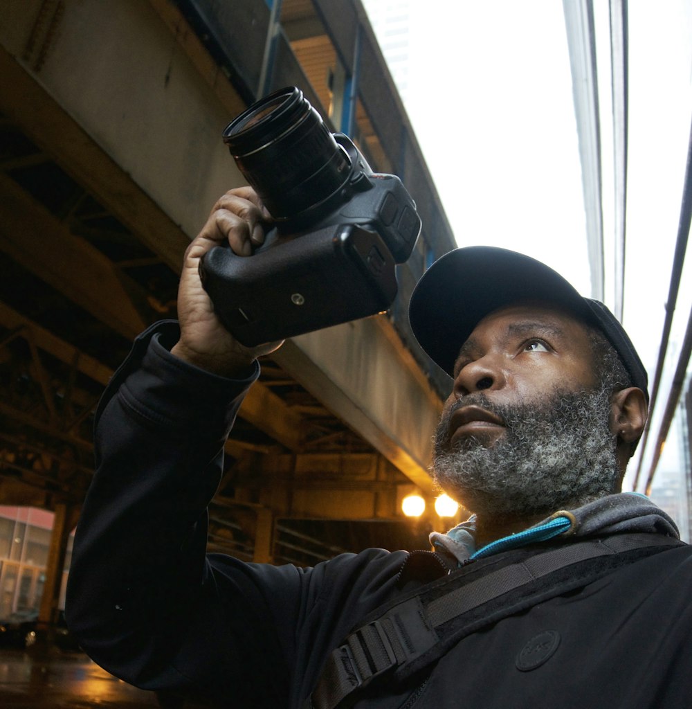 a man holding a camera up to his face