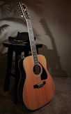 a wooden guitar sitting on top of a table