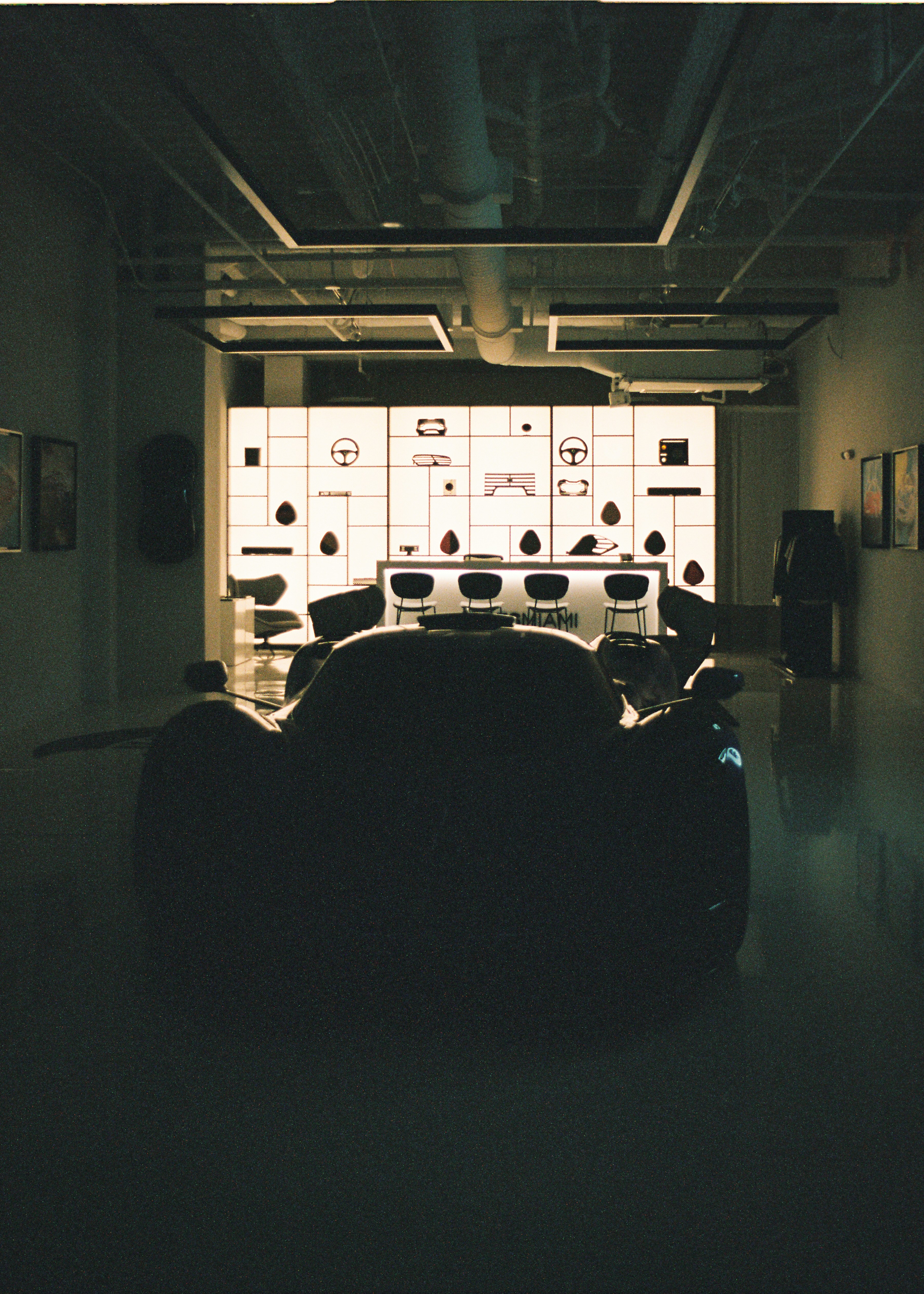 a car is parked in a dimly lit garage
