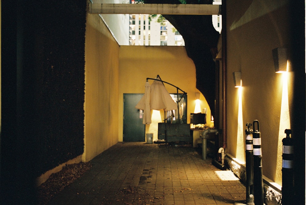 a hallway with a lamp and clothes hanging on the wall