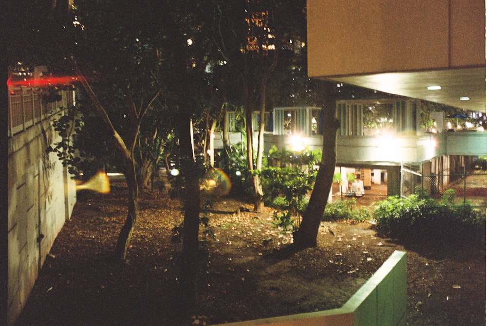 a night time view of a building and trees