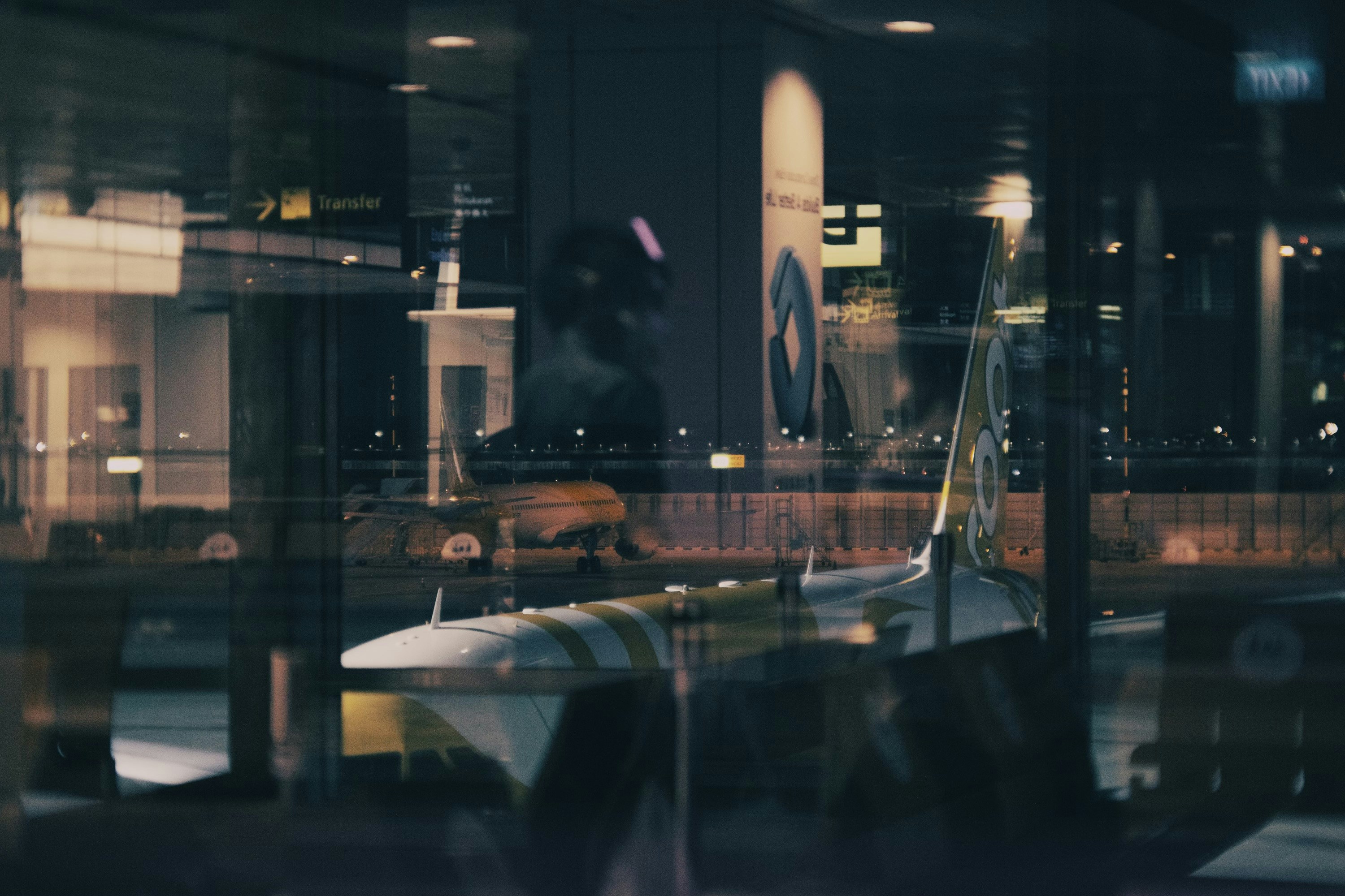 a plane is seen through a glass window, 