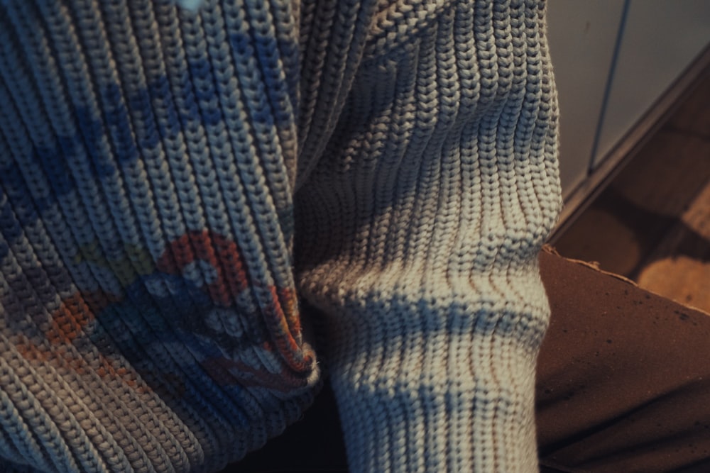 a close up of a person wearing a sweater