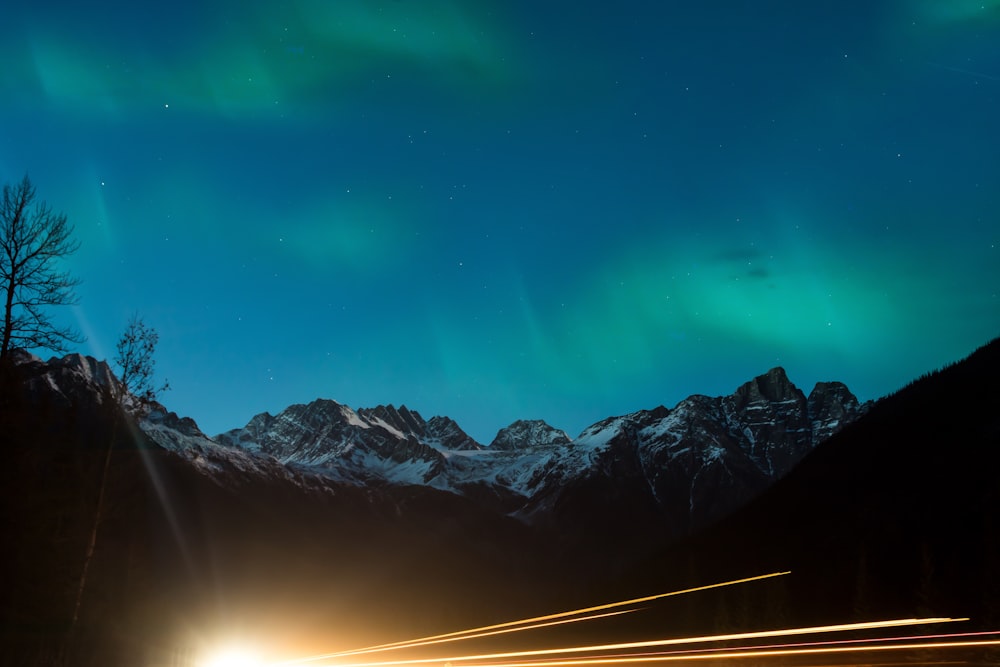 a car driving down a road under a green light