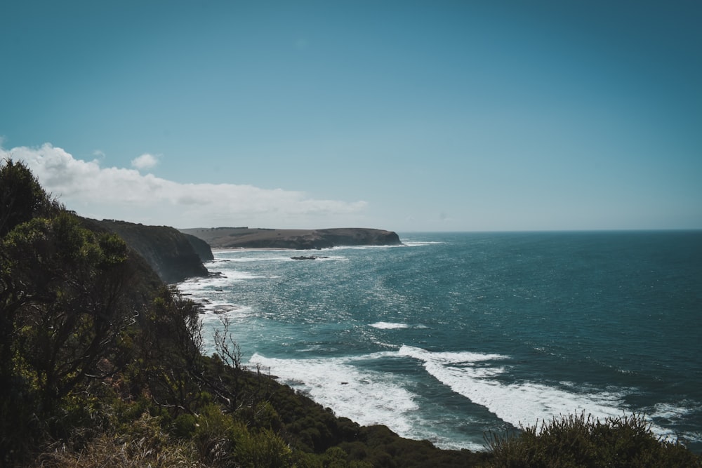 a view of the ocean from the top of a hill