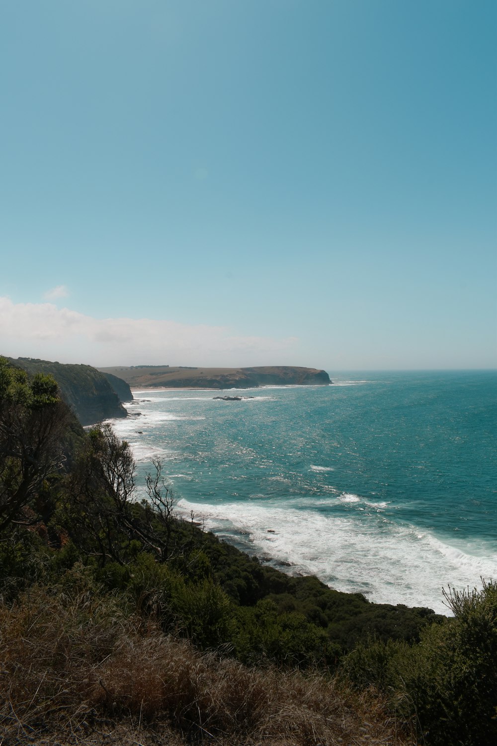 a view of the ocean from the top of a hill