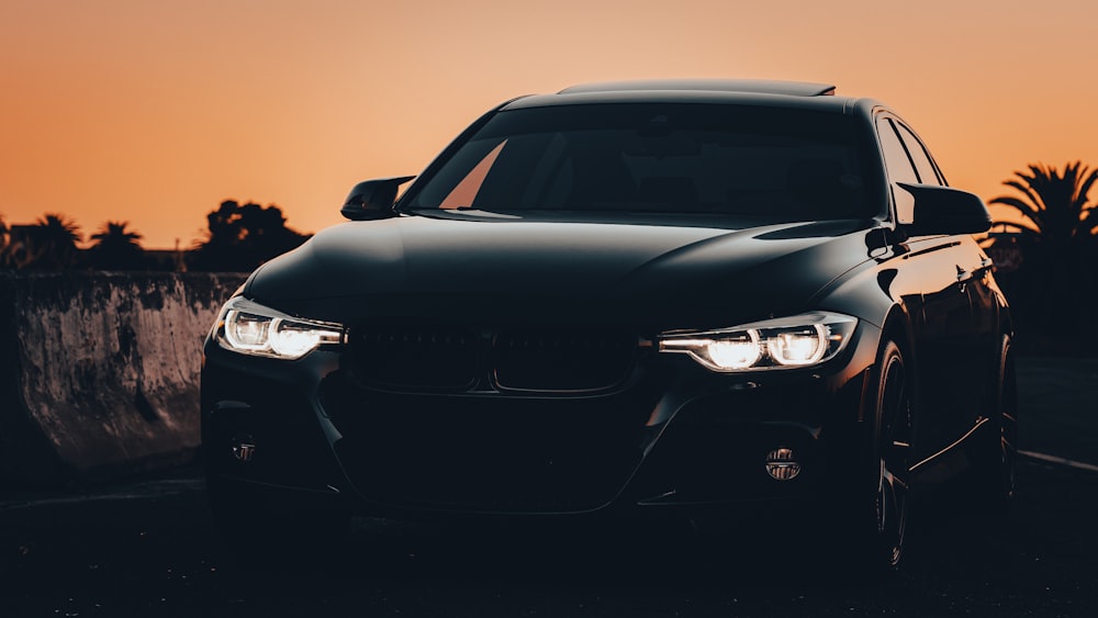 a black car parked on the side of a road