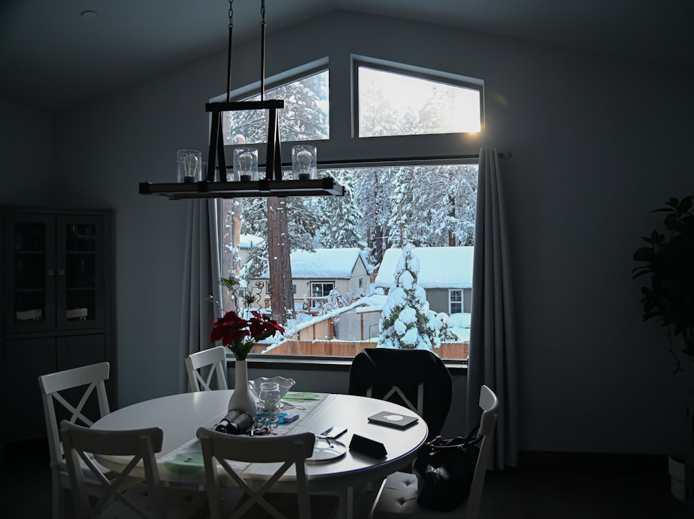 a dining room table with a vase of flowers on it