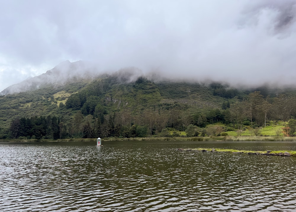 a body of water with a mountain in the background