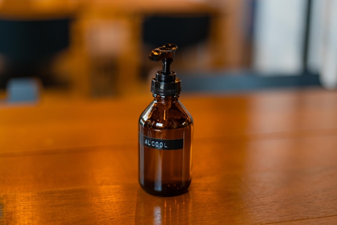 a glass bottle sitting on top of a wooden table