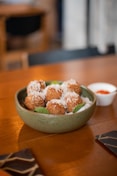 a bowl of food sitting on top of a wooden table