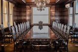 a large conference room with a chandelier hanging from the ceiling