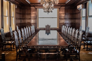 a large conference room with a chandelier hanging from the ceiling