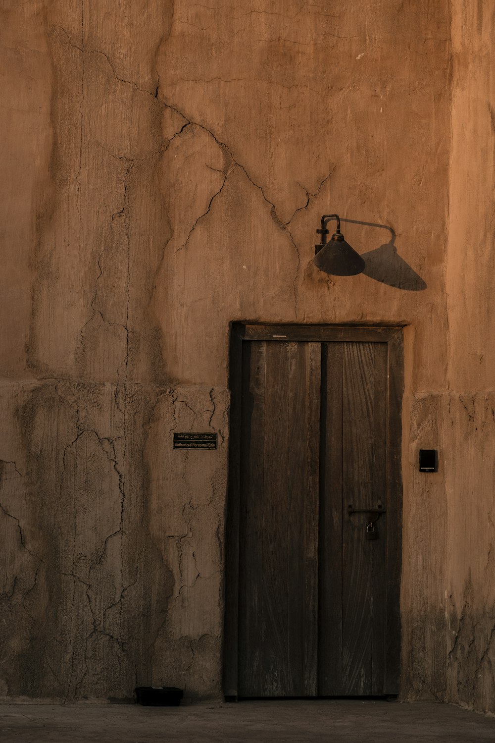 a wall with a door and a light on it