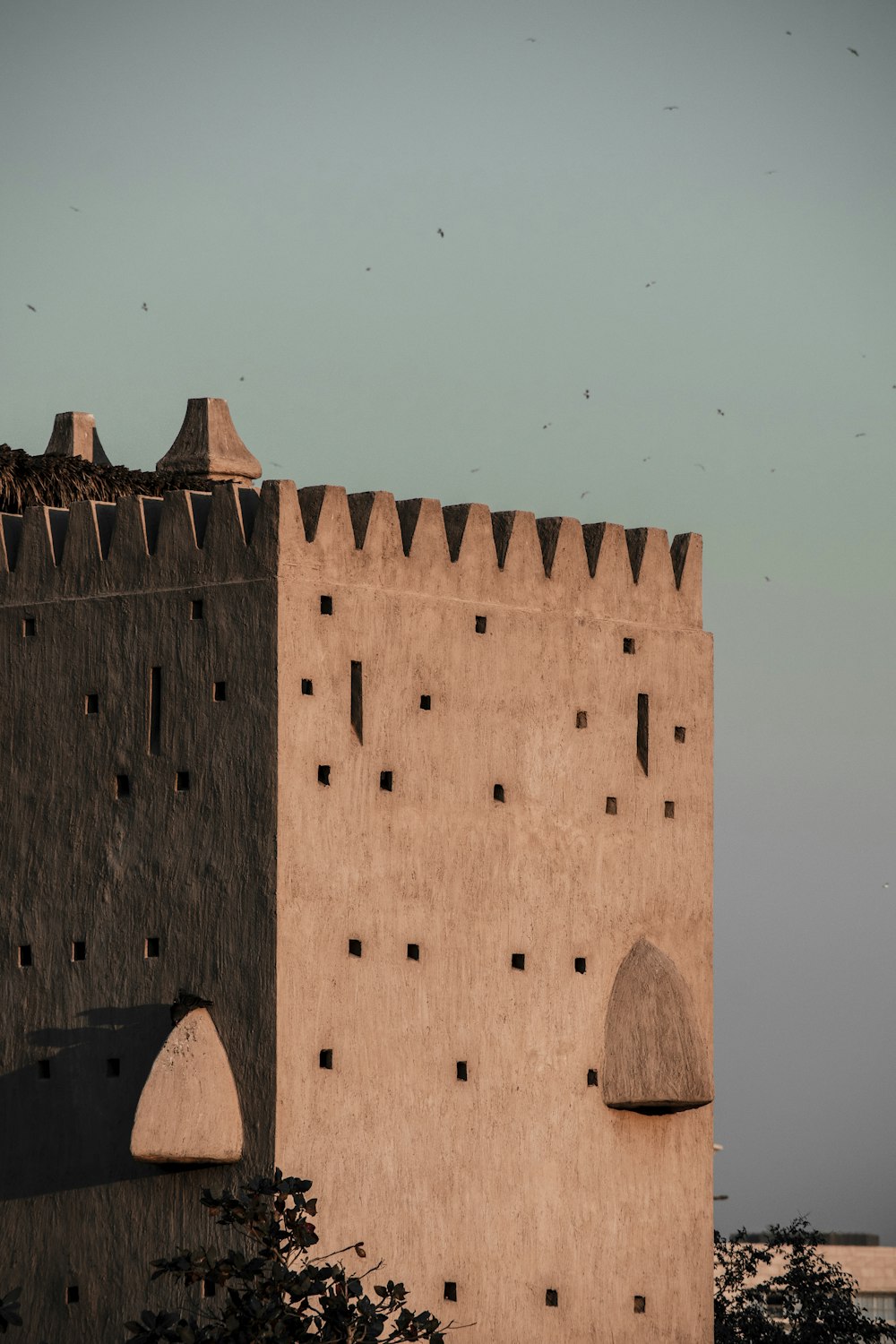 a large brick building with a sky background