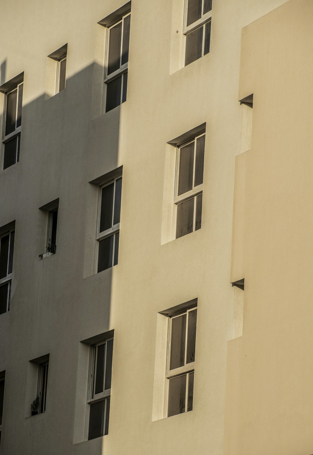 a building with several windows and a clock on the side of it