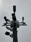 a traffic light with multiple cameras attached to it