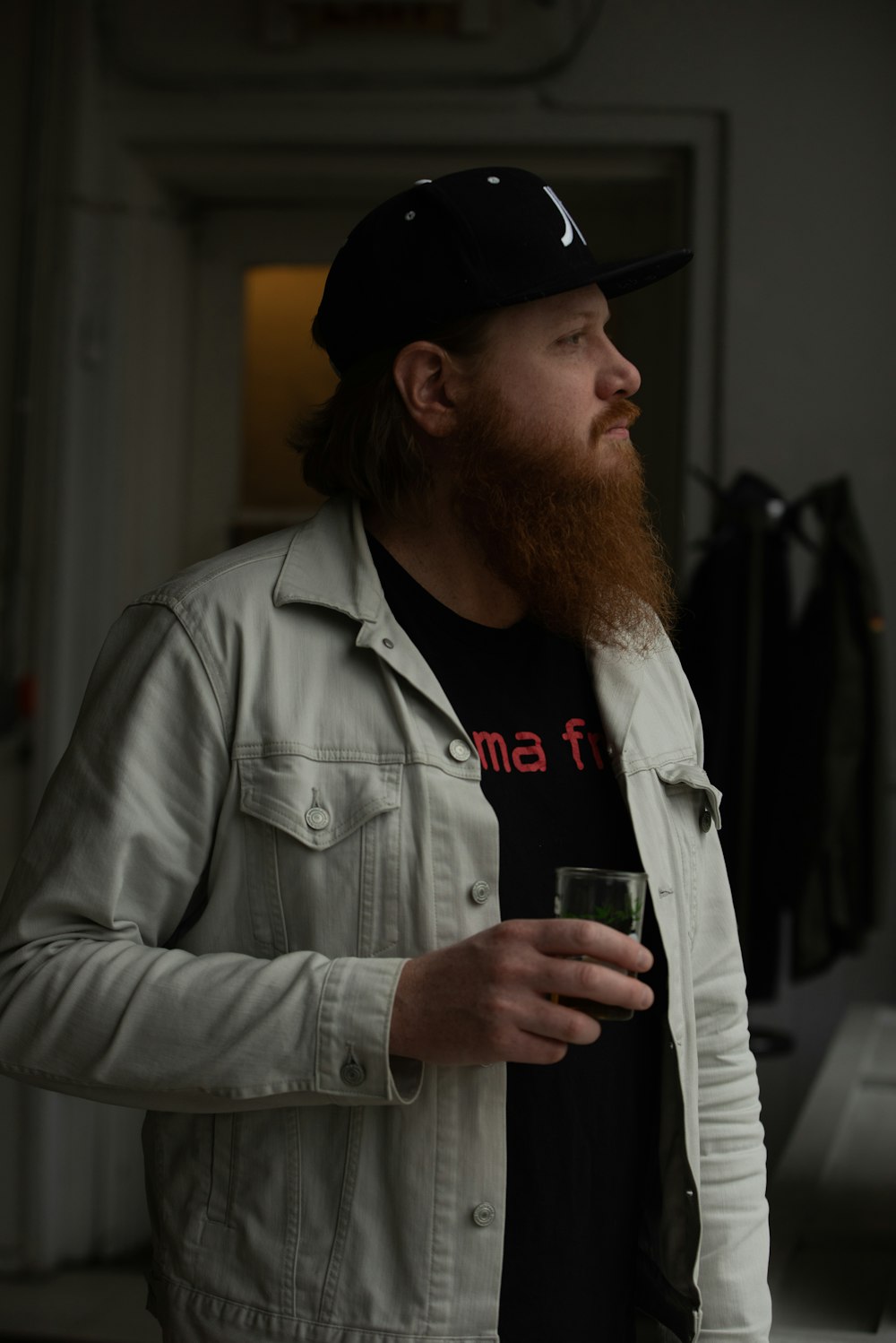 a man with a beard is holding a drink