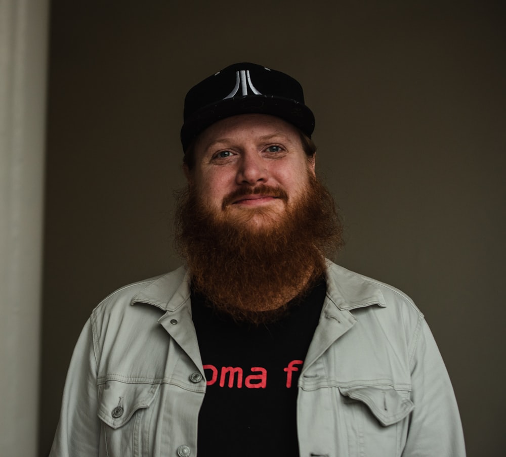 a man with a beard wearing a hat