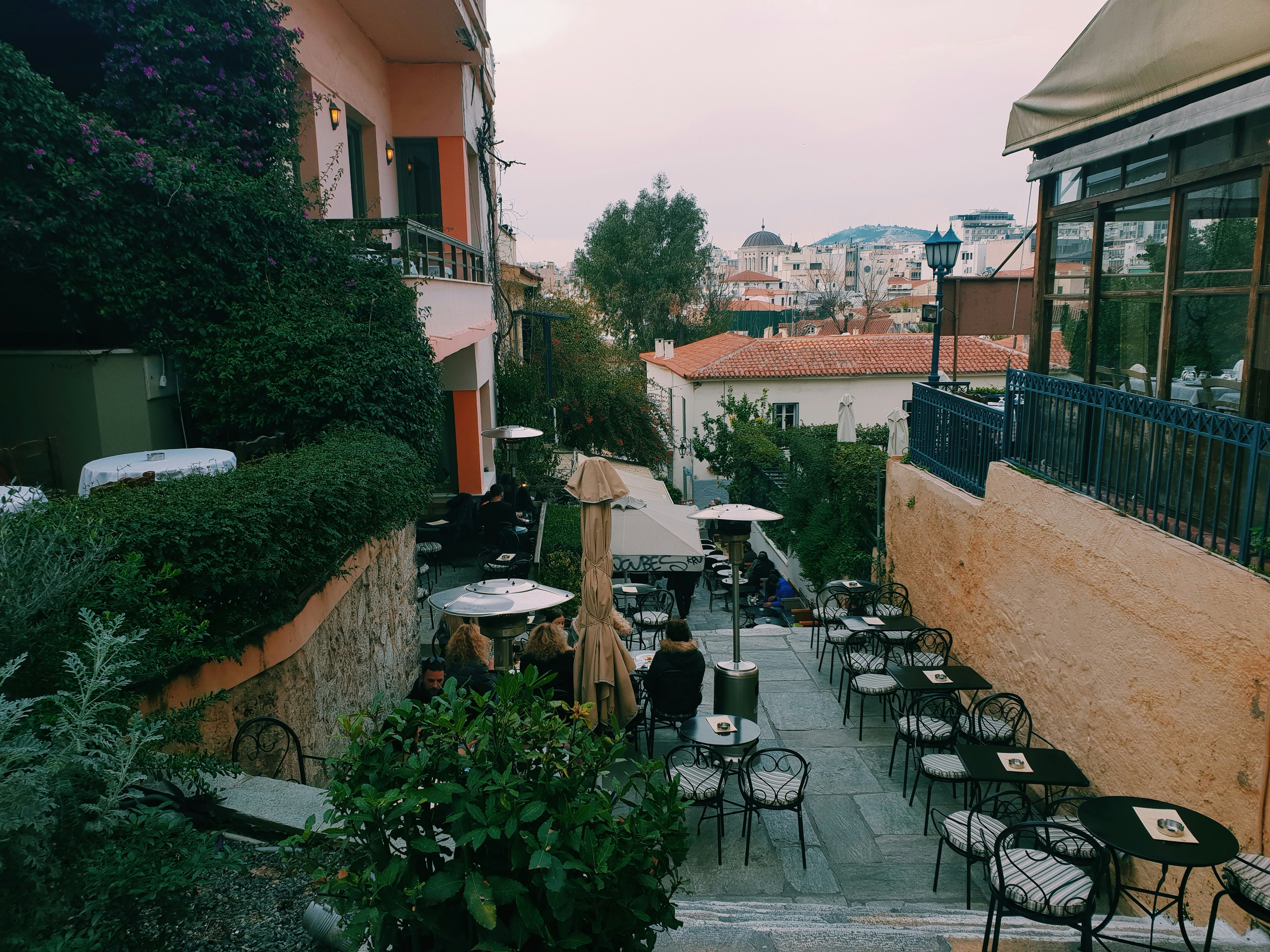 an outdoor patio with tables and chairs and umbrellas