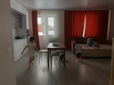 a little boy and a little girl playing in a living room