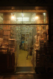 Stacks of carefully packed books ready for shipment in a cozy warehouse.
