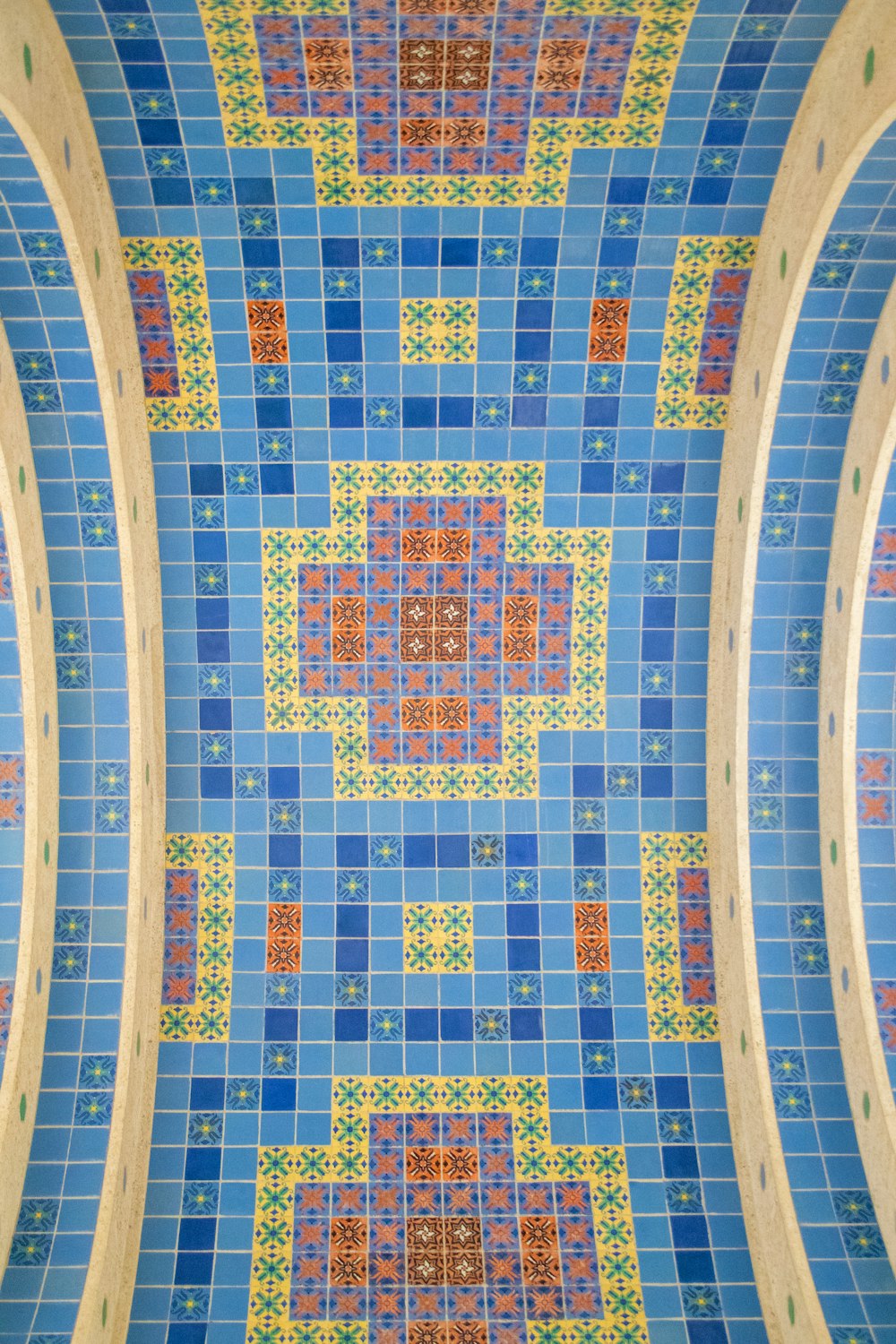 a blue and yellow tiled ceiling in a bathroom